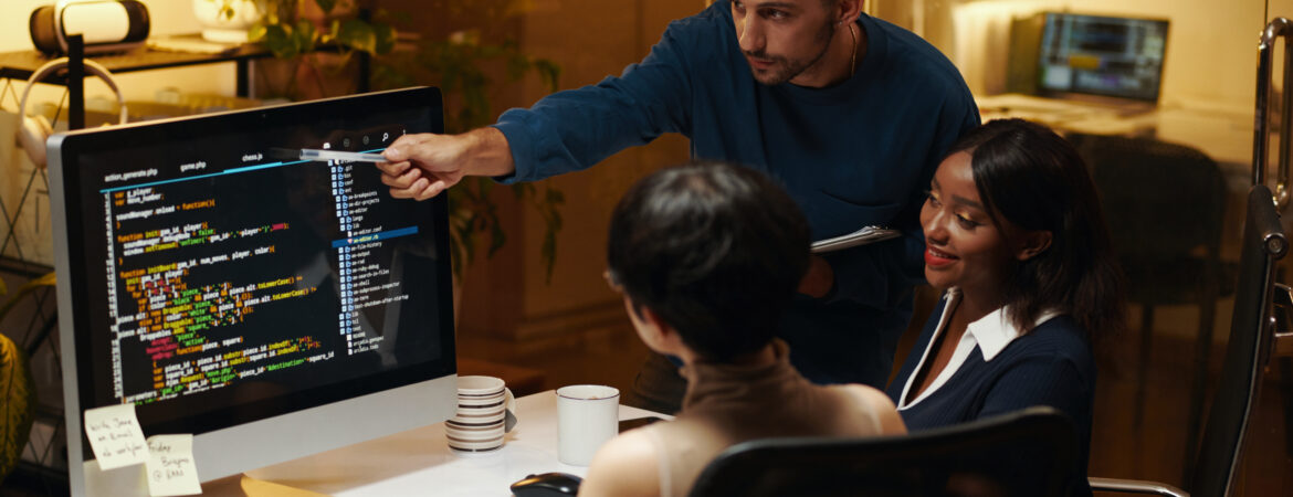 Developer explaining details in programming code his colleagues from front end team